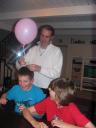 William getting a balloon from his dad, Rob, with brother Harry looking on