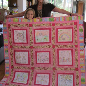 Jannae with the Art Quilt that Grandma Shirley made for her (she drew the pictures when she was 5 and 6 years old.)