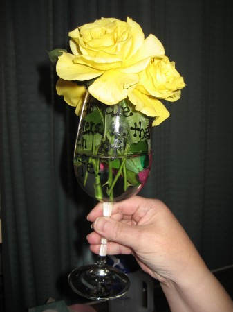 Catherine's hand holding a YELLOW ROSE OF TEXAS