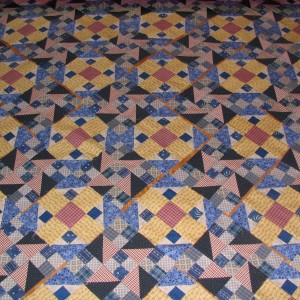 The top laid out of the Pineapple Crush Mystery Quilt