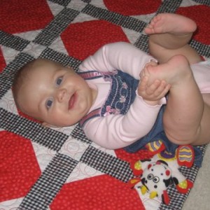 Happy Birthday Tara Lynn (on the baby quilt that I made for her!)