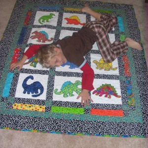 Vincent LOVES his Dinosaur Party Quilt